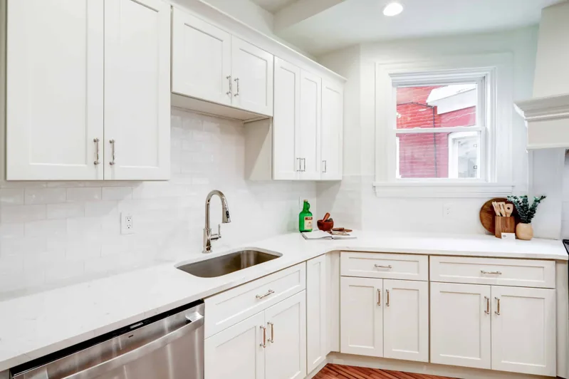 White kitchen cabinets with a subway tile backsplash