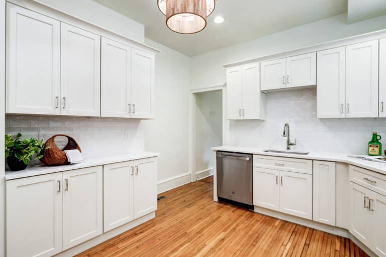 Kitchen cabinet run with a sink, dishwasher, range and ceiling lighting