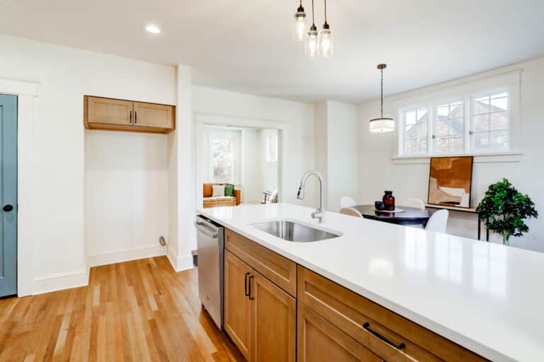 Natural wood kitchen island with drawers, cabinet doors and dark handles