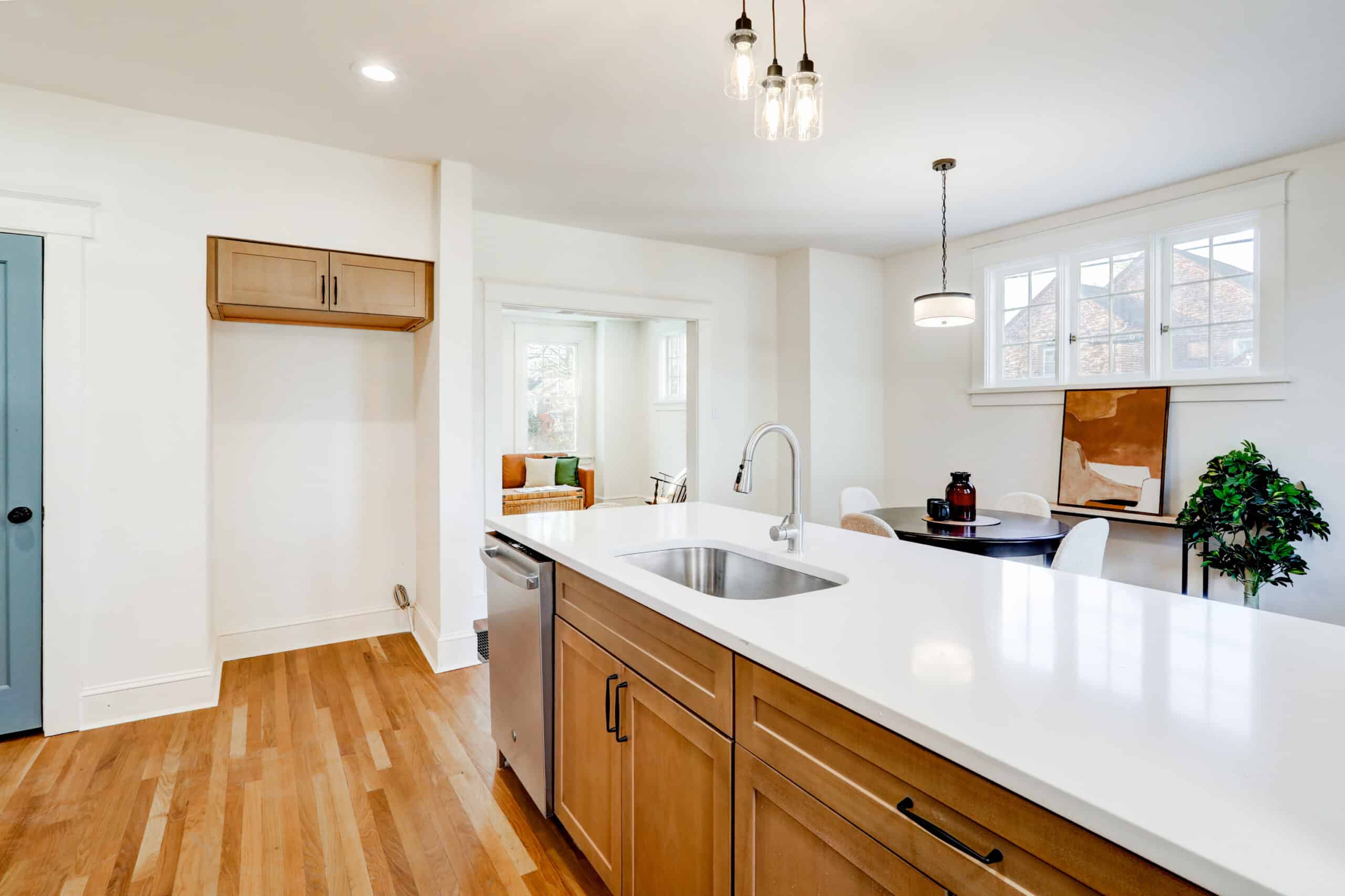 Natural wood kitchen island with drawers, cabinet doors and dark handles