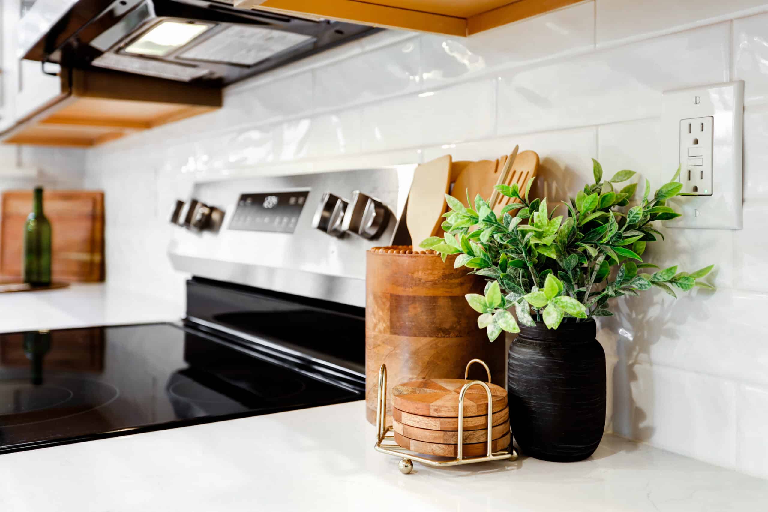 Stainless steel range and over-the-range microwave surrounded by wood cabinetry