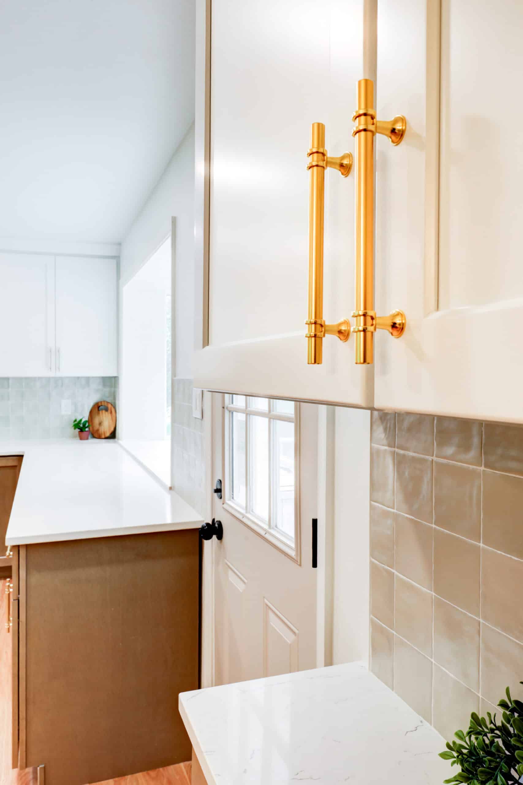 White kitchen cabinet doors and drawers with gold-tone handles